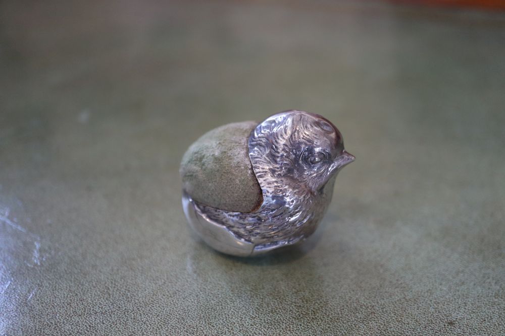 An Edwardian novelty silver mounted pin cushion modelled as a hatching chick, Sampson Mordan & Co
